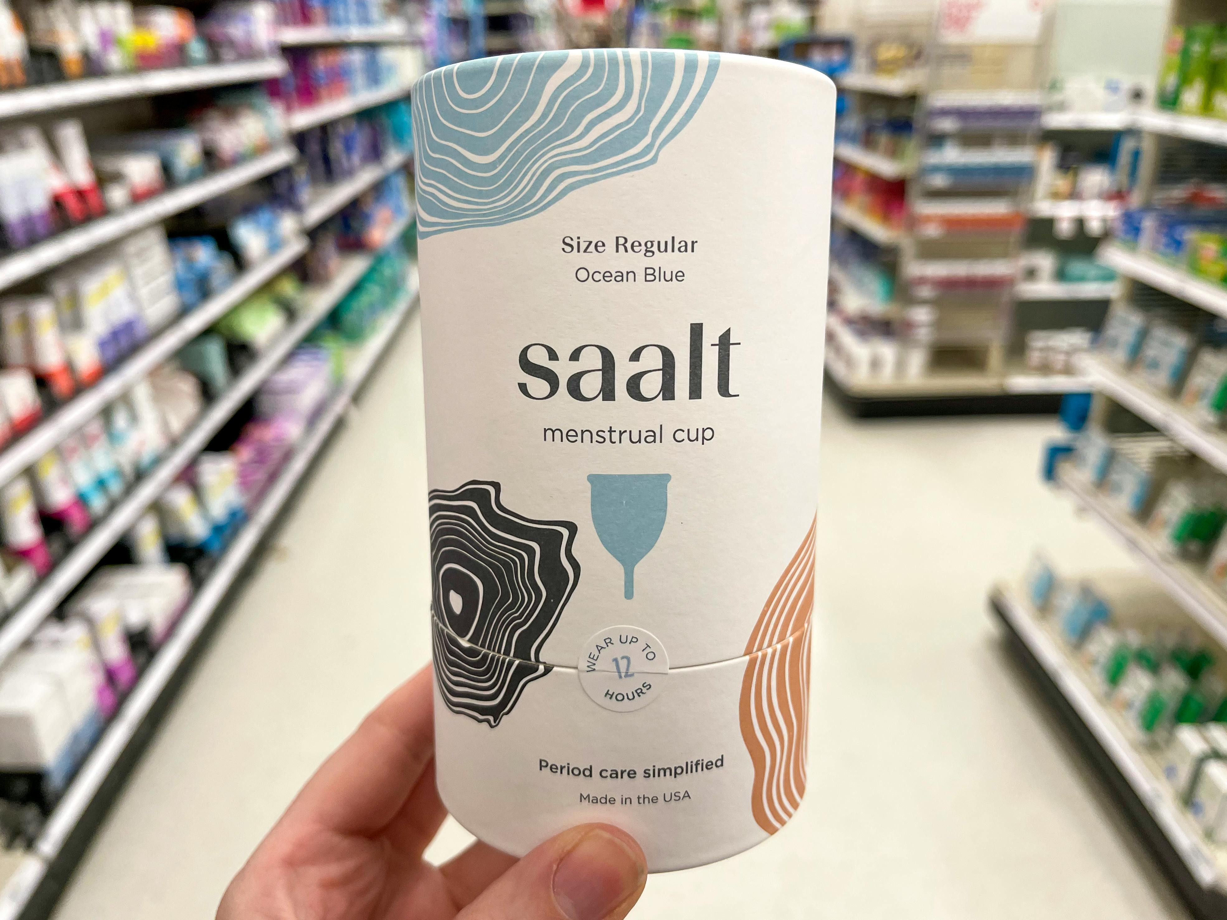 A person holding a box holding a Saalt menstrual cups at Target