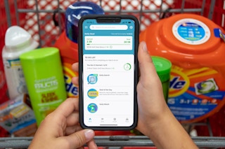 A person holding a smartphone with swagbucks website open.