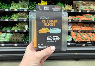 violife just like cheese cheddar slices held in front of walmart produce