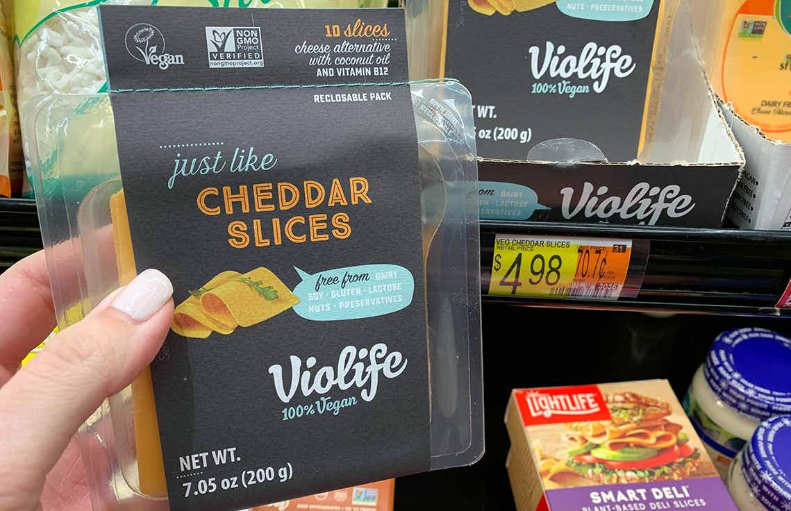 violife just like cheese cheddar slices held next to walmart price tag