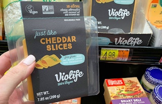violife just like cheese cheddar slices held next to walmart price tag