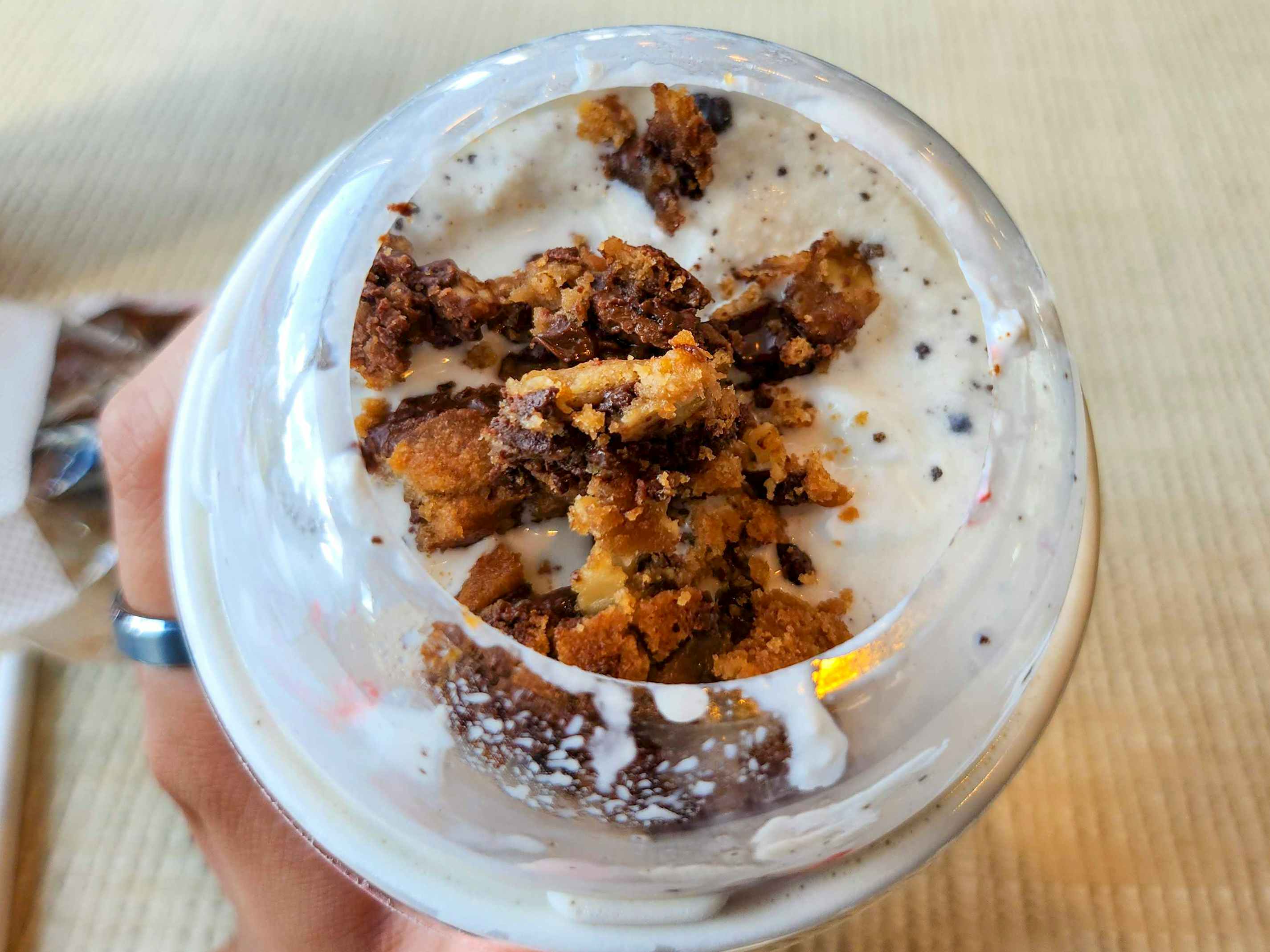 A close up on a Chick-fil-A milkshake with cookie crumbles added to it.