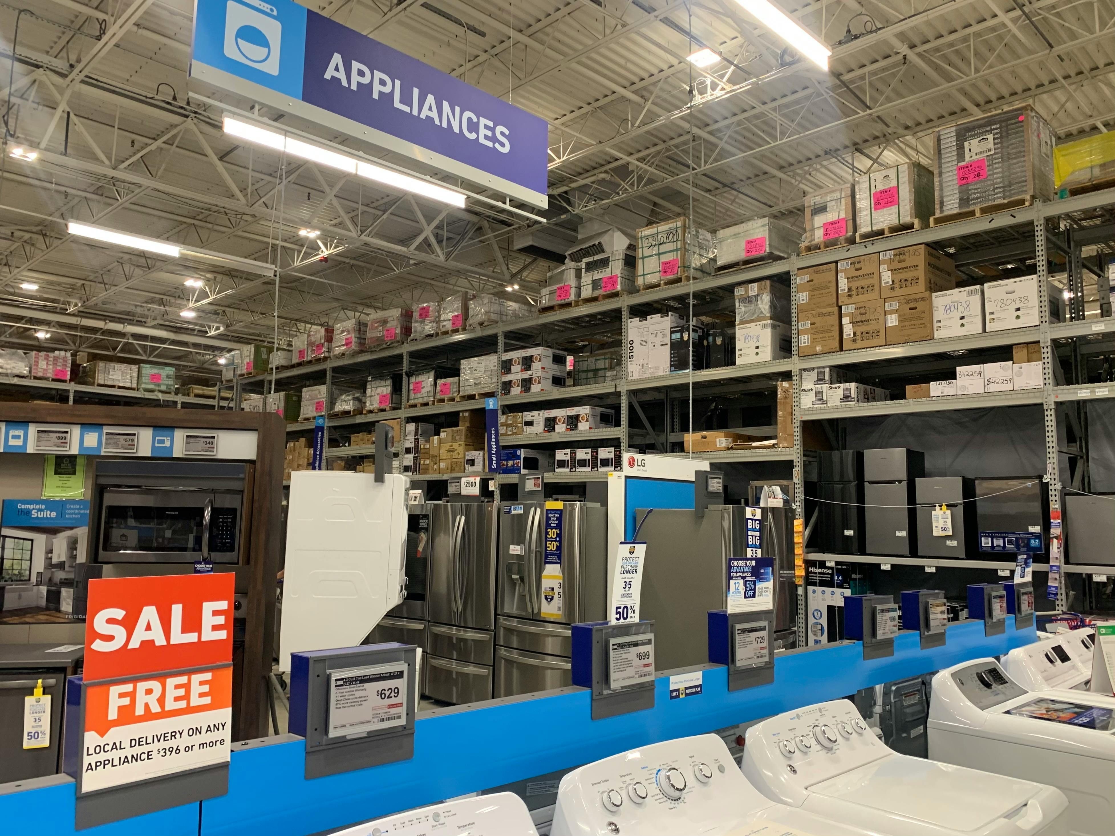 lowes appliance section in store with sale sign