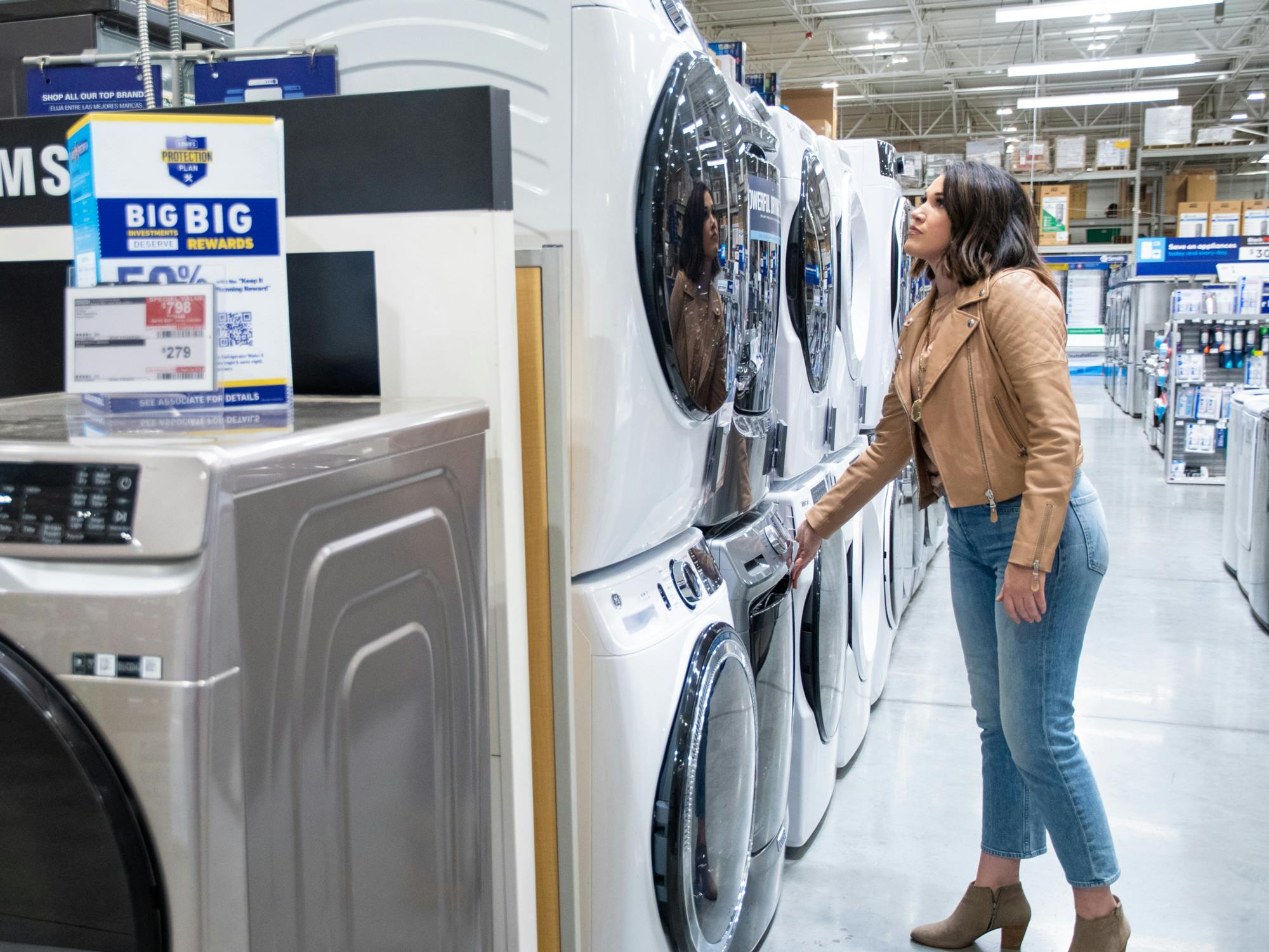 a person looking at the washer and dryers at Lowe's
