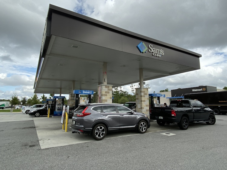Vehicles parked at gas pumps at a Sam's Club gas station.
