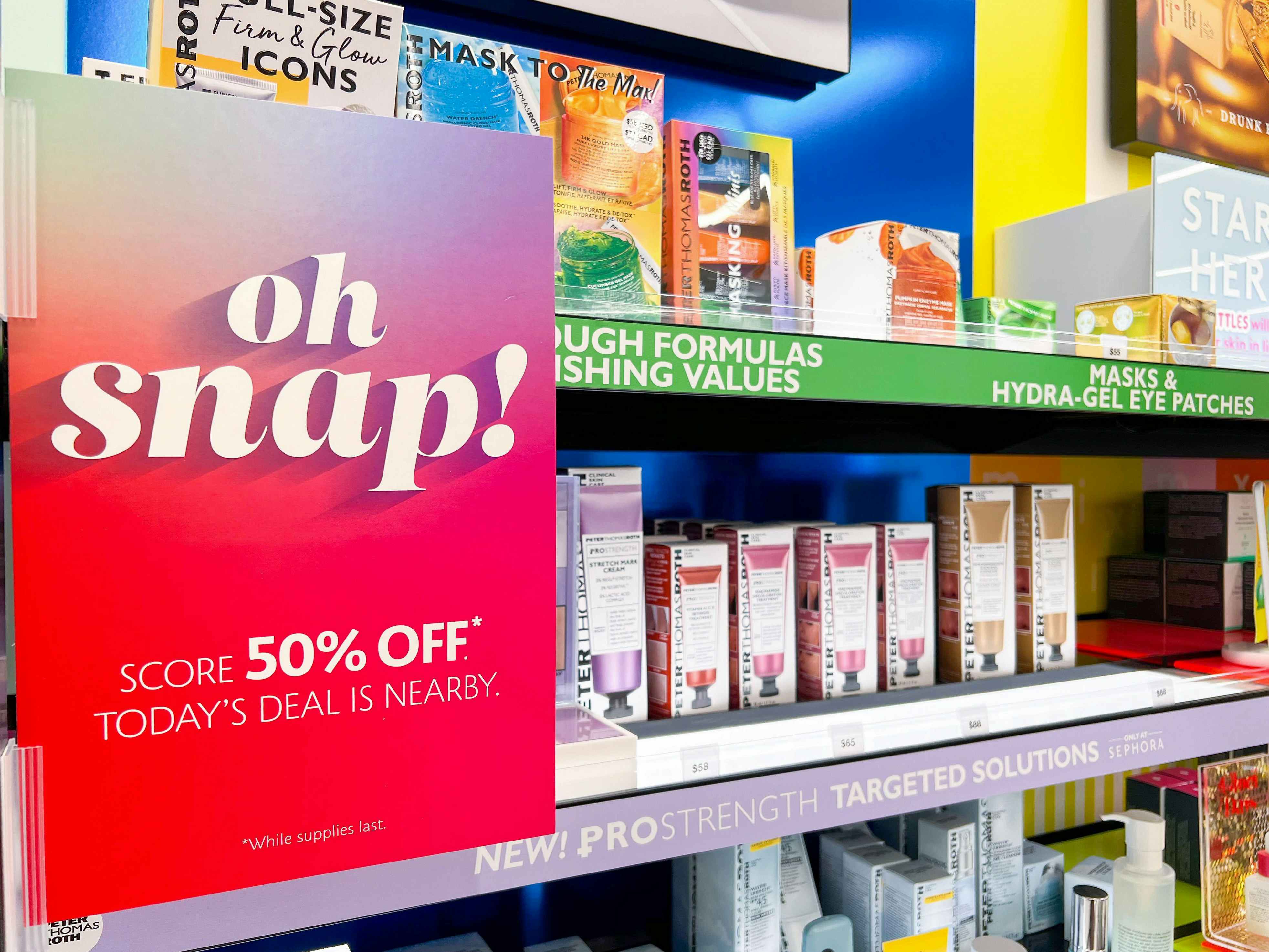A sign for Sephora's Oh Snap sale attached to a shelf inside Sephora