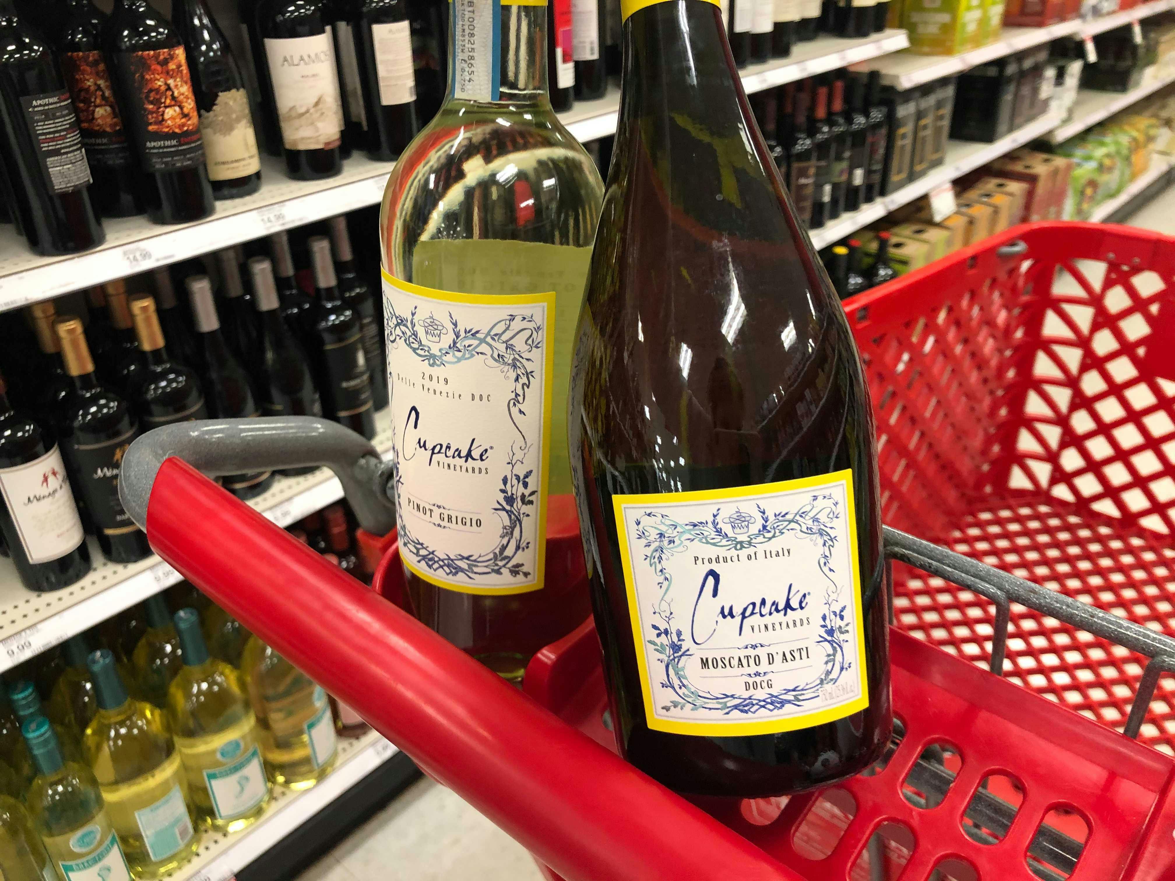 Two bottles of Cupcake Vineyards wine sitting on the top of a Target shopping cart in the Beer & Wine aisle at Target.