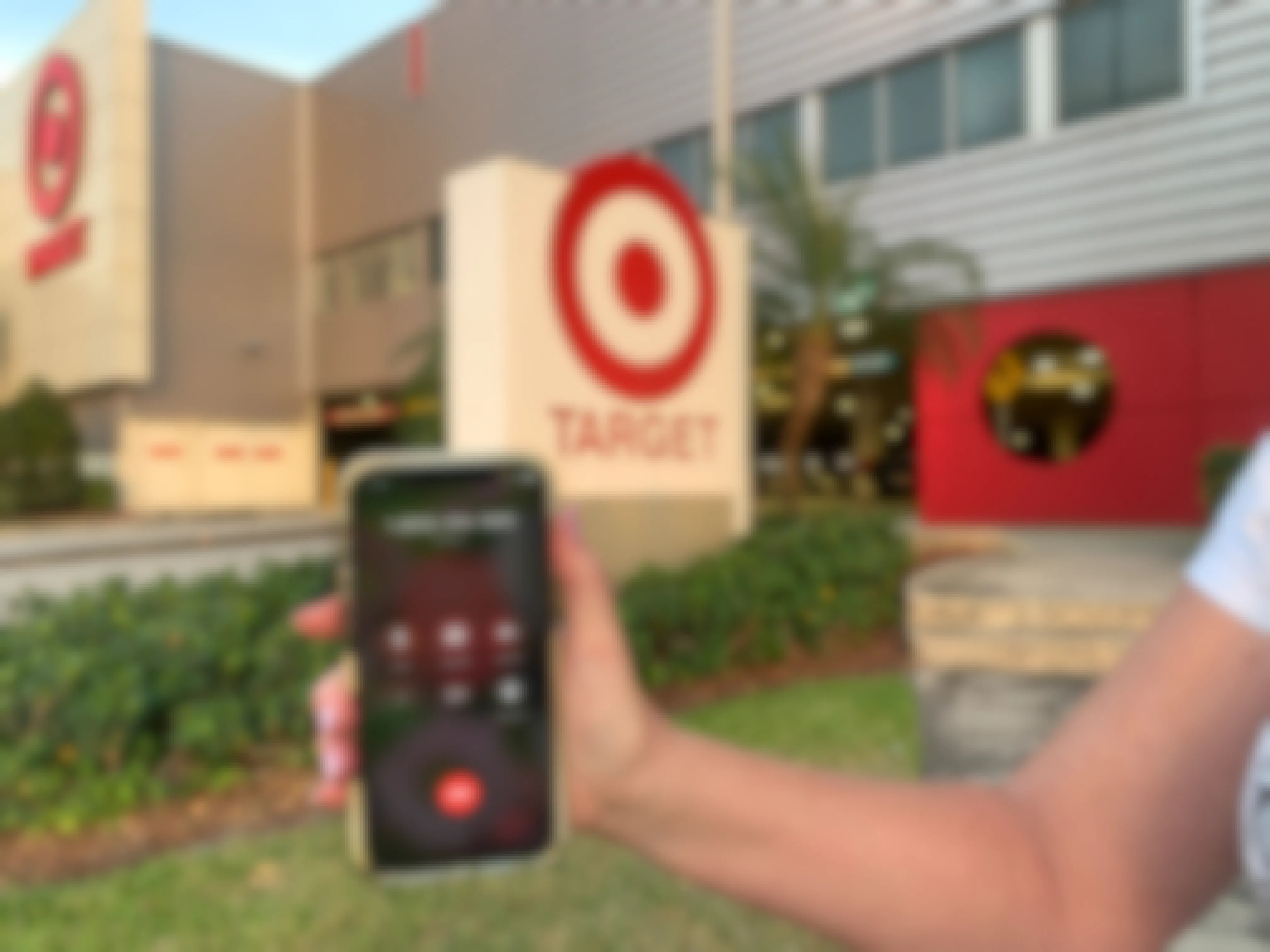 hand holding cellphone in front of target calling target call center 