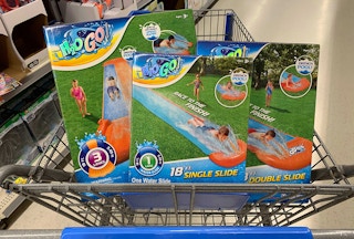 Three H2O Go lawn water slides in the basket of a Walmart shopping cart.