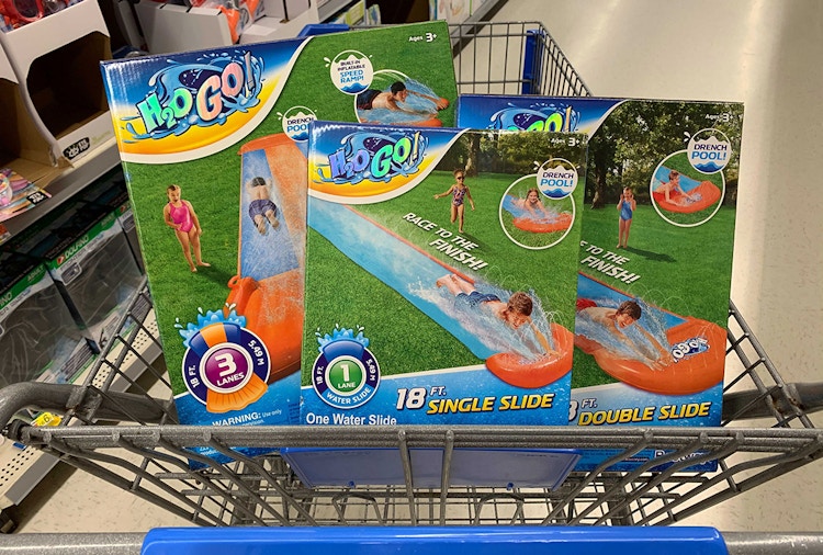 Three H2O Go lawn water slides in the basket of a Walmart shopping cart.