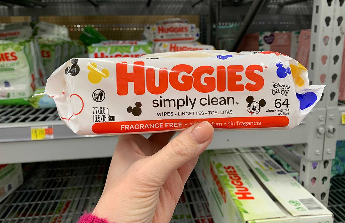 Someone holding up Huggies wipes at Walmart