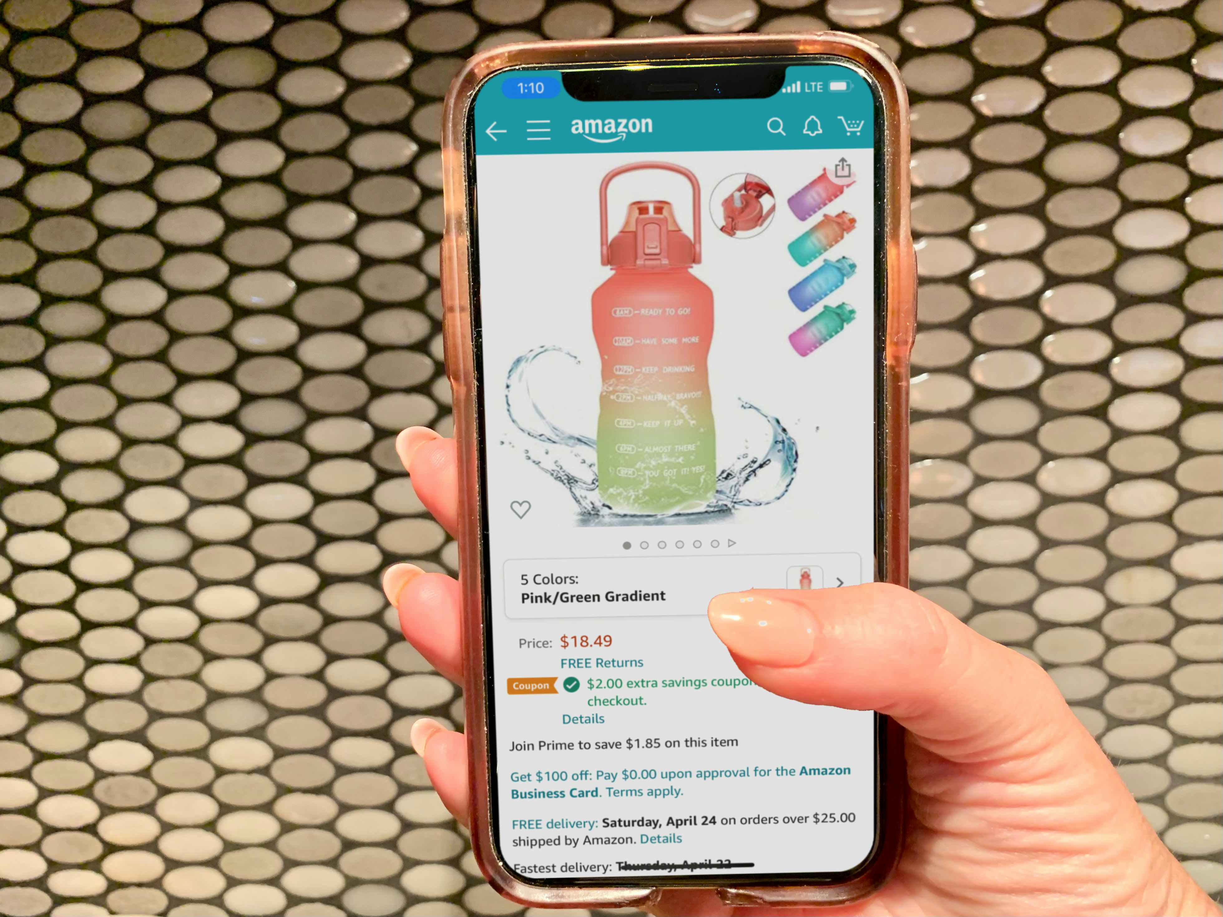 someone holding phone with amazon water bottle