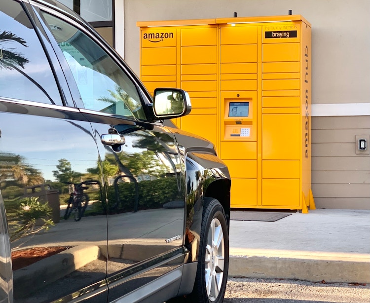outside amazon hub locker near parked car