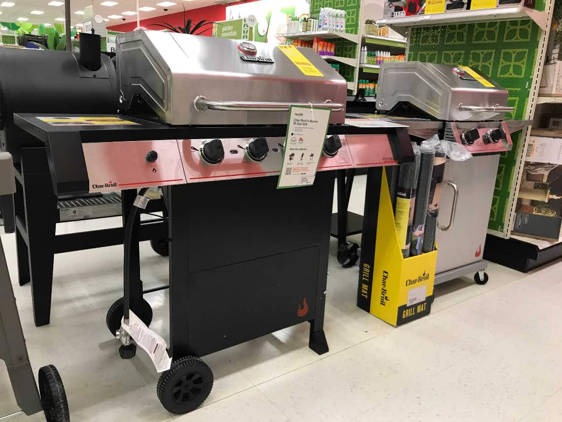 Large grill set up next to a slightly smaller grill. Both are in front of an aisle.