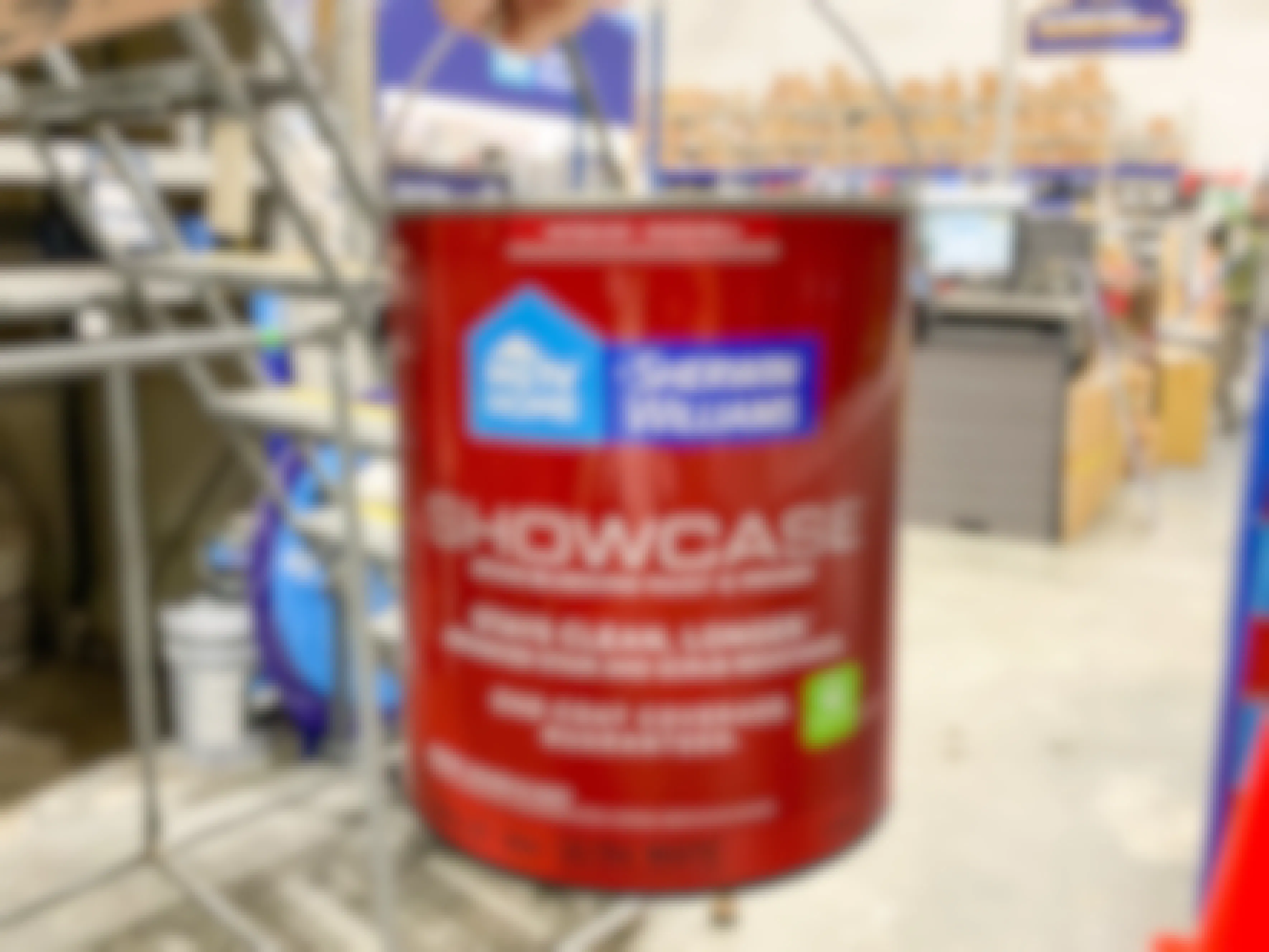 hand holding gallon of hgtv sherwin-williams paint in lowes store