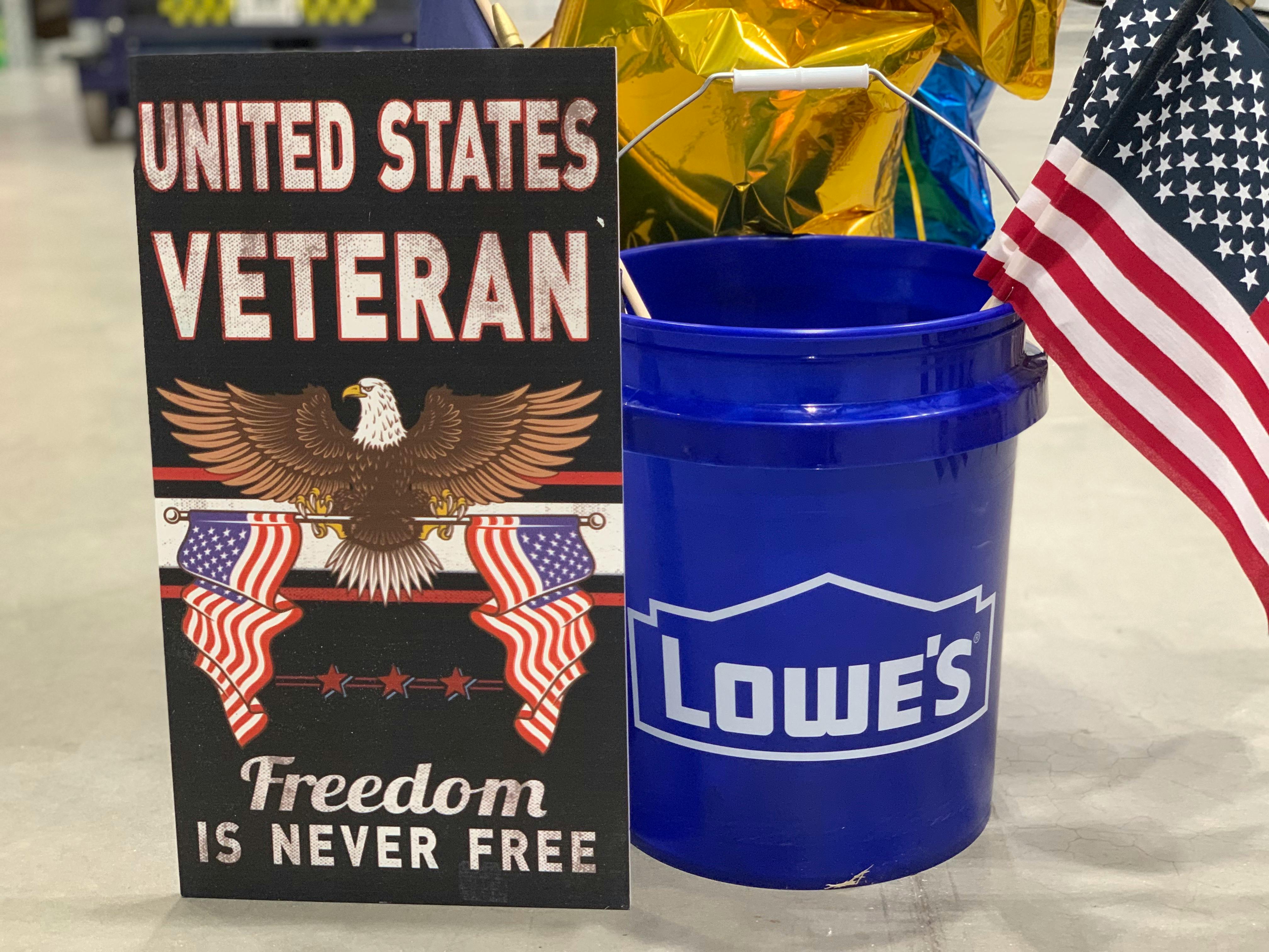 veteran sign with lowes bucket full of american flags