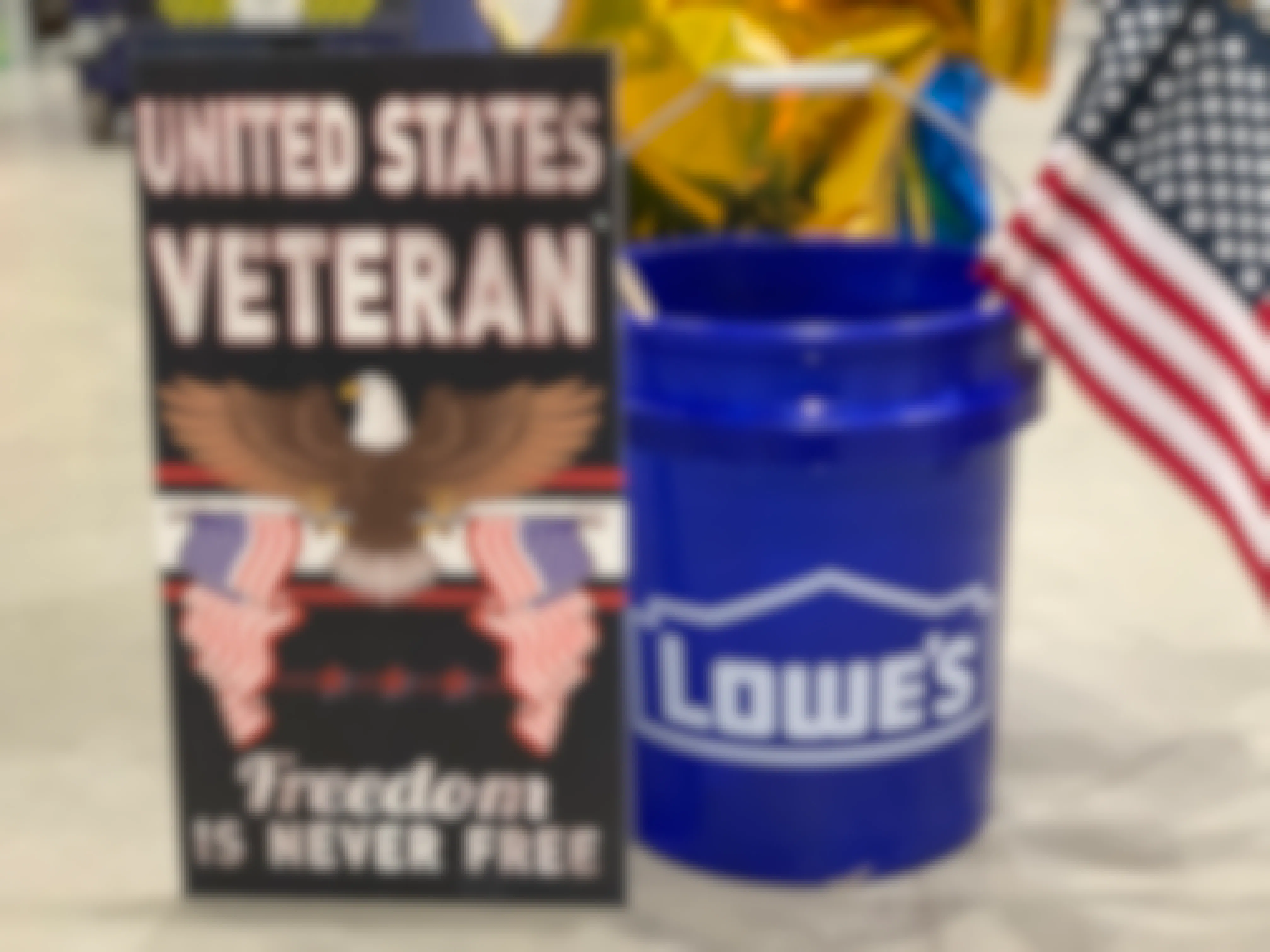 veteran sign with lowes bucket full of american flags