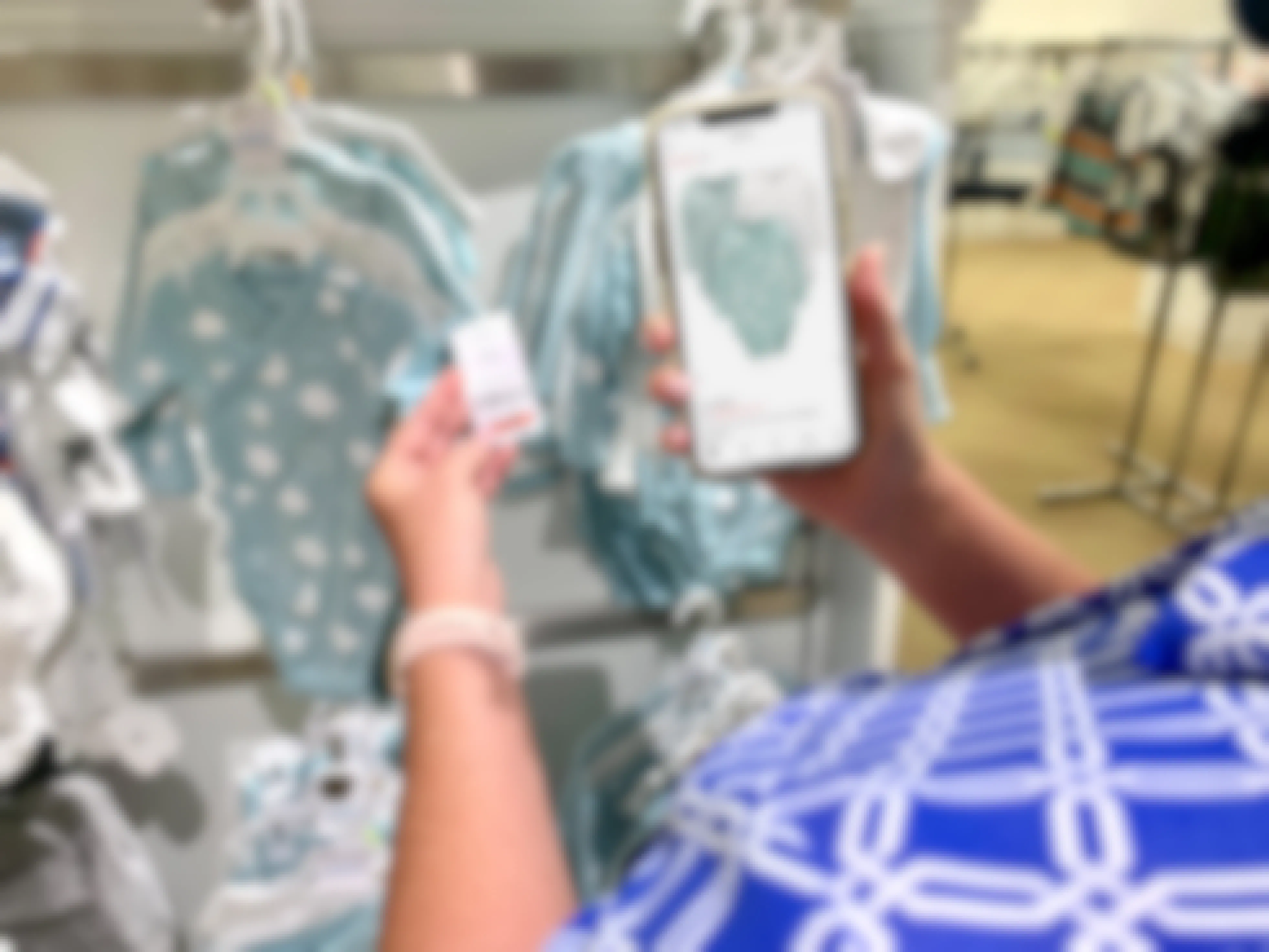 cwoamn comparing price on app and on baby clothes on rack 