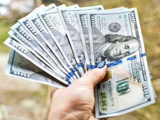 a hand holding cash