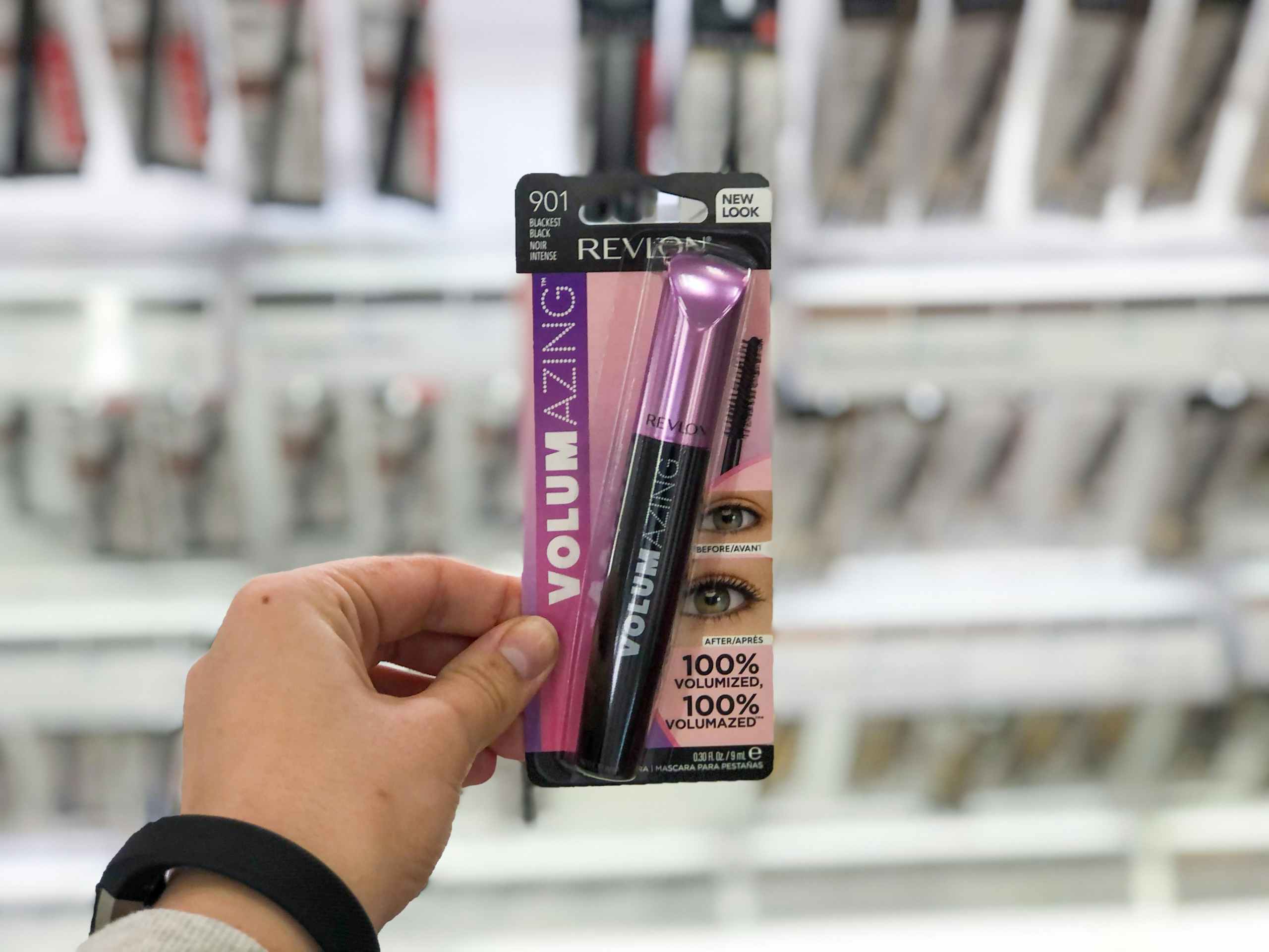 person holding mascara in target aisle