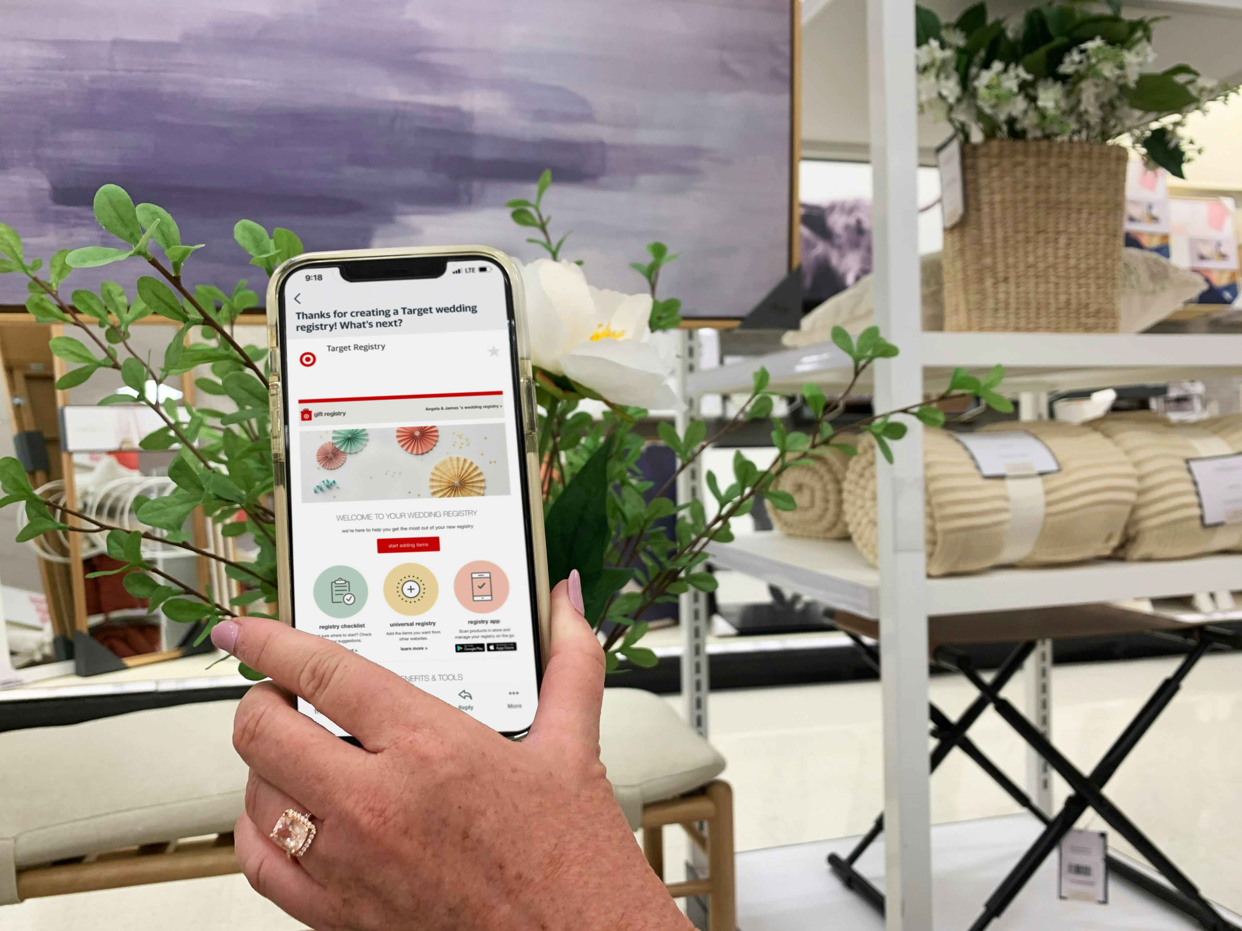 hand holding cellphone with target regisrty app in home decor section of store