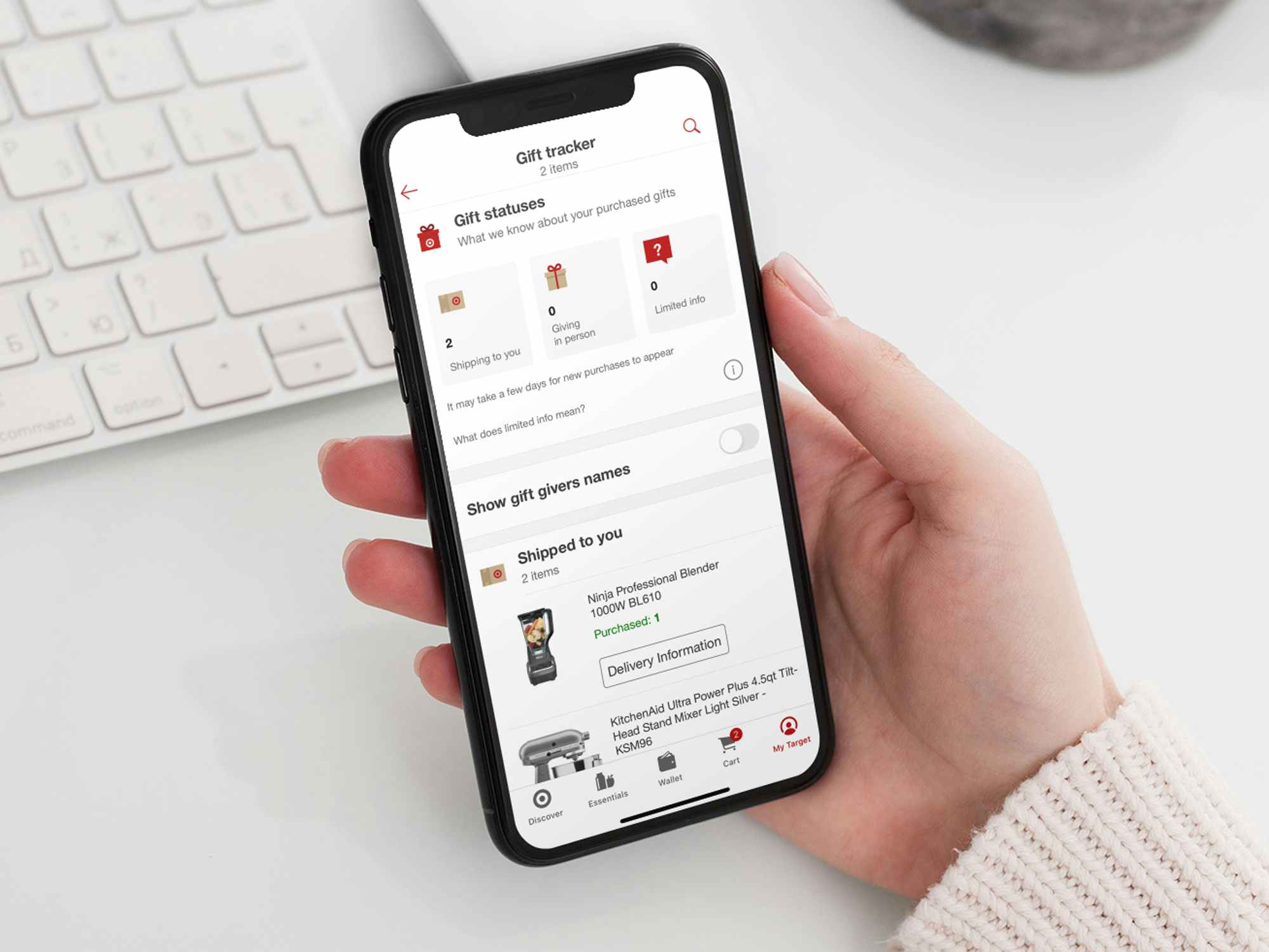 a hand holding a phone open to the target app, showing the gift tracker on the target wedding registry page