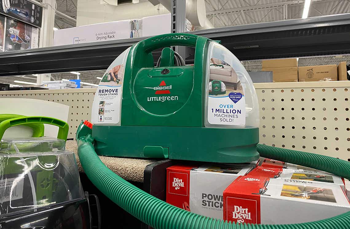 bissell little green cleaner machine on a walmart shelf with the hose wrapped around the machine