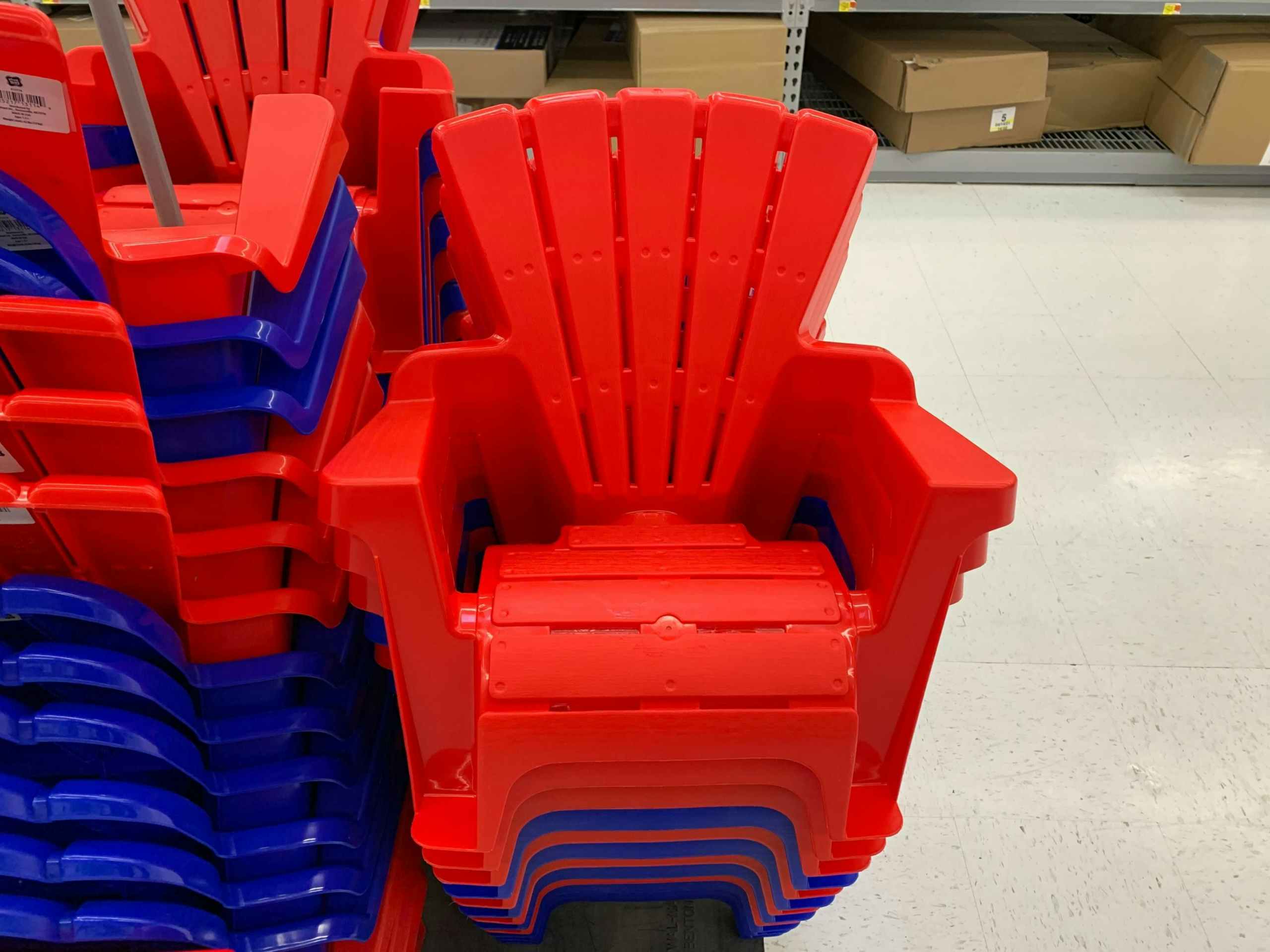 red plastic kids adirondack chairs stacked at walmart
