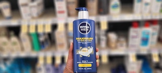 hand holding bottle of men's nivea lotion