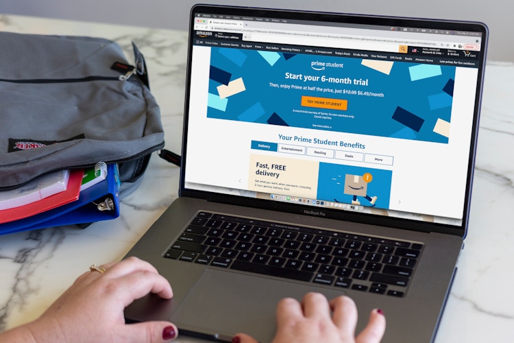 A person sitting at a laptop computer with the Amazon Prime Student sign up page open on the screen.