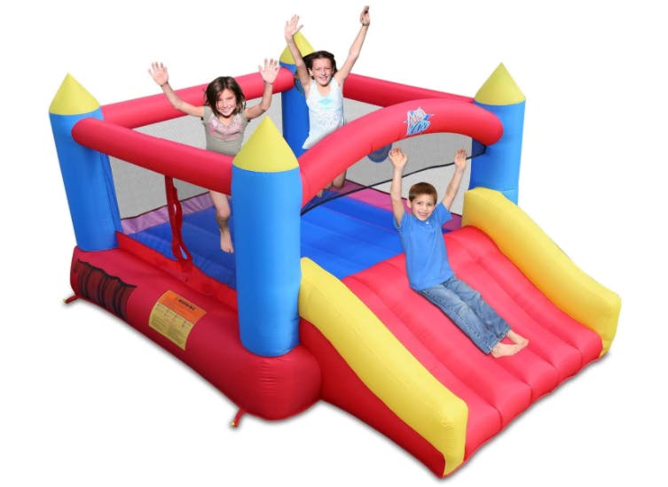 Kids playing in a castle bounce house.