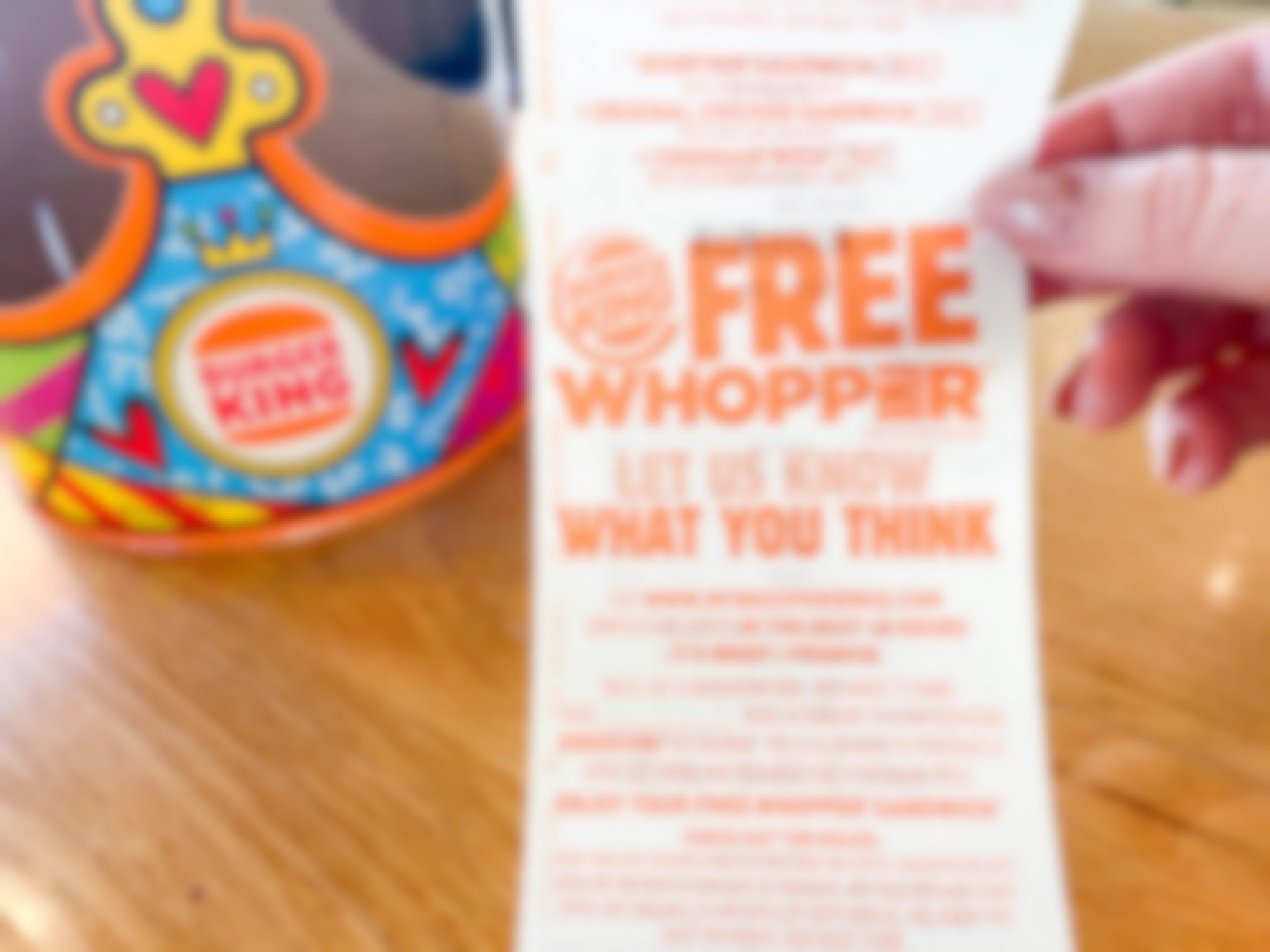 a burger king receipt being held up in front of kids crown
