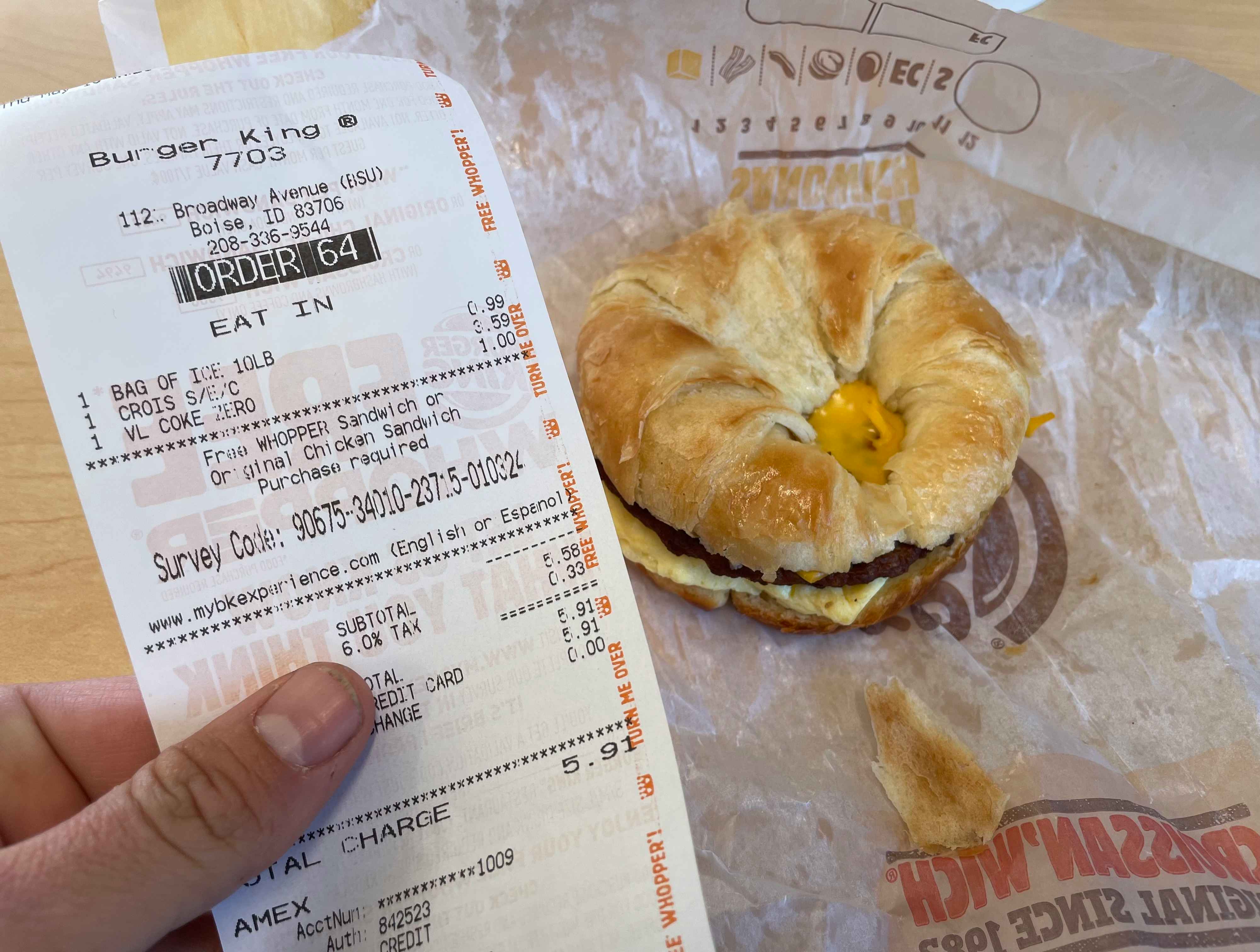A person holding a burger king receipt.