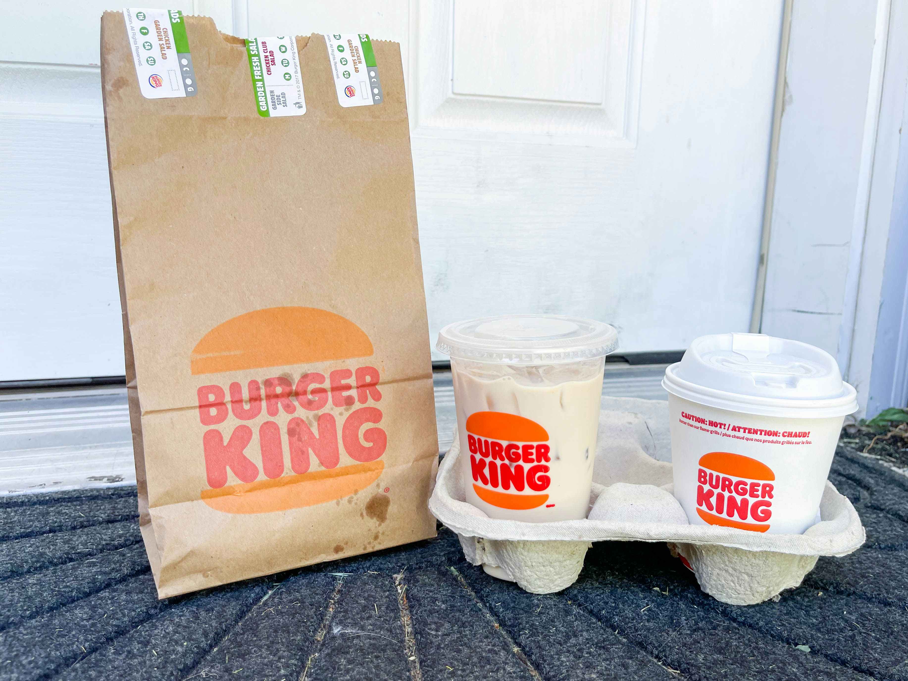 a burger king meal sitting on a front porch