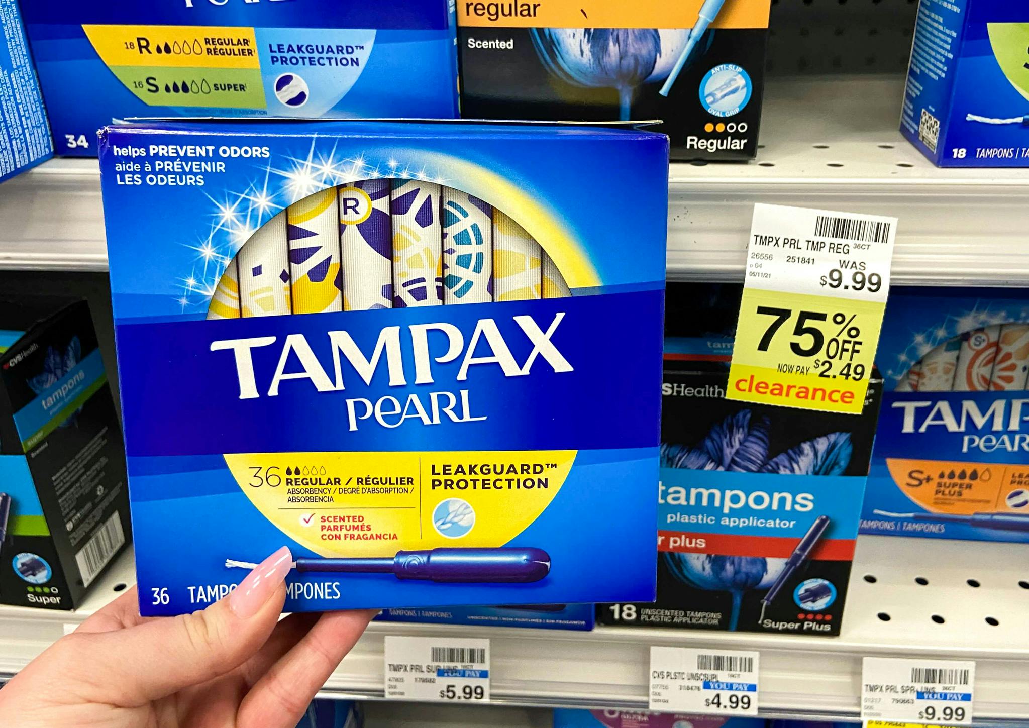 someone holding tampax tampons at cvs