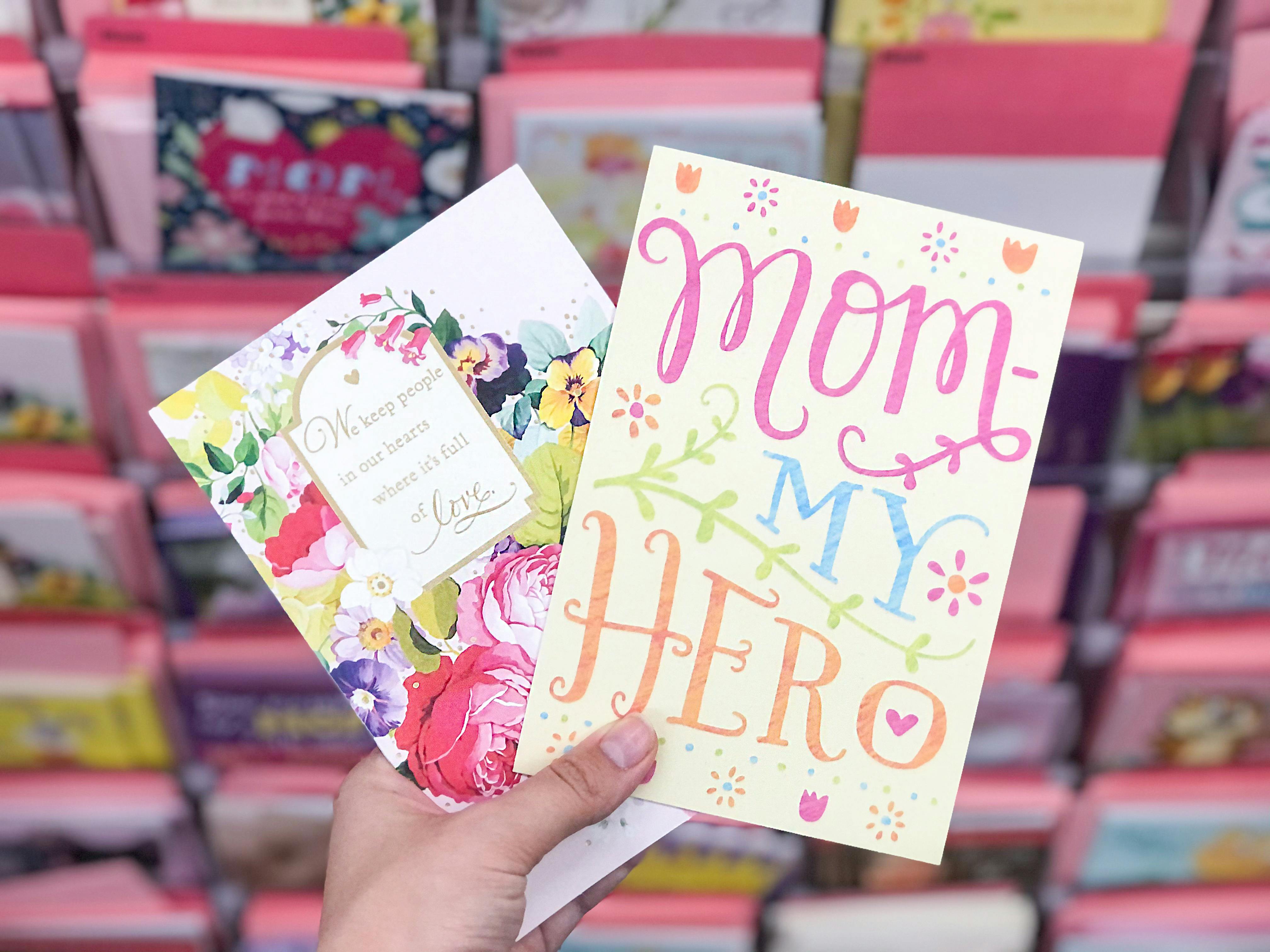 hand holding mothers day cards at dollar tree