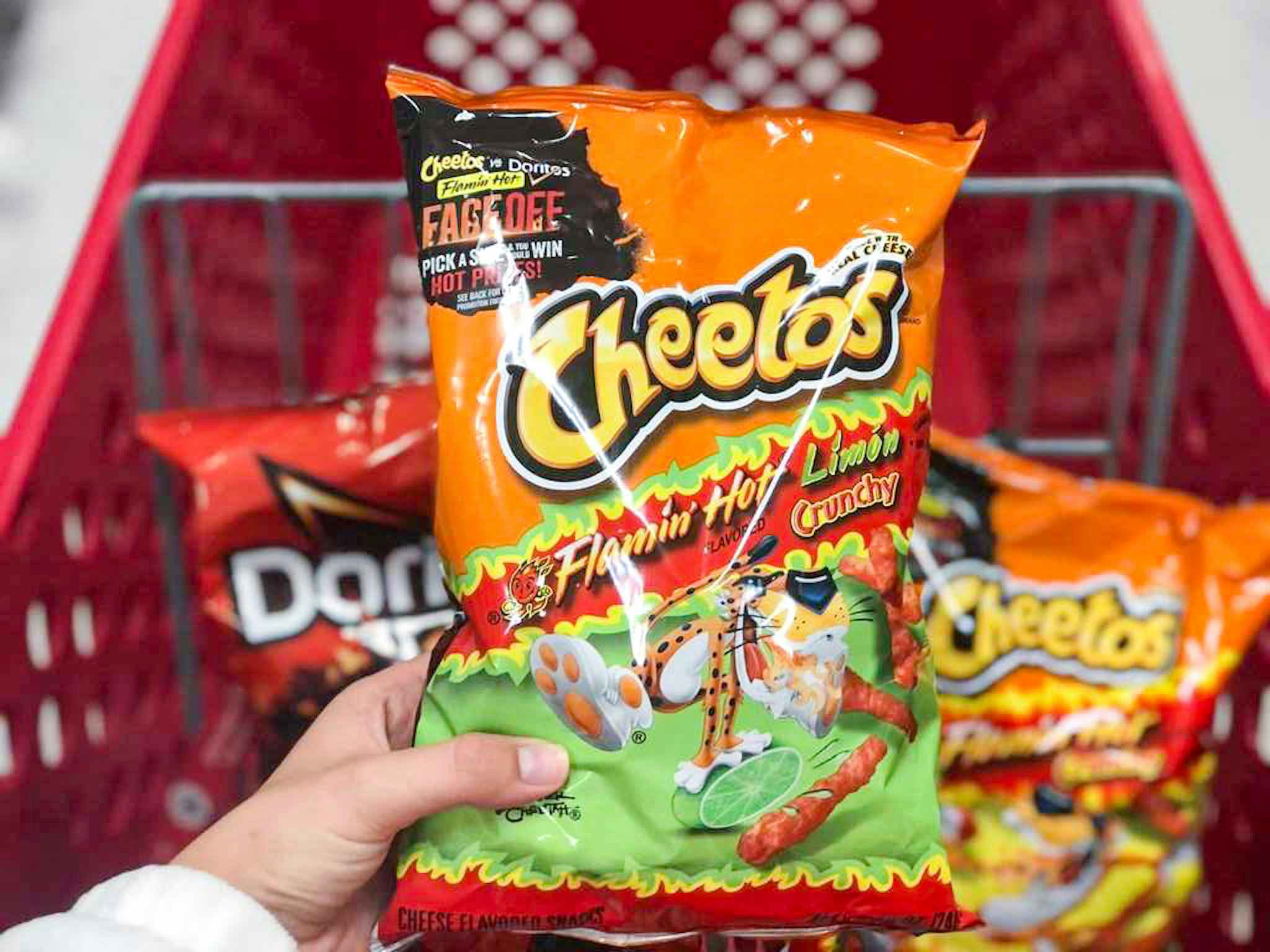 hand holding a bag of cheetos at target