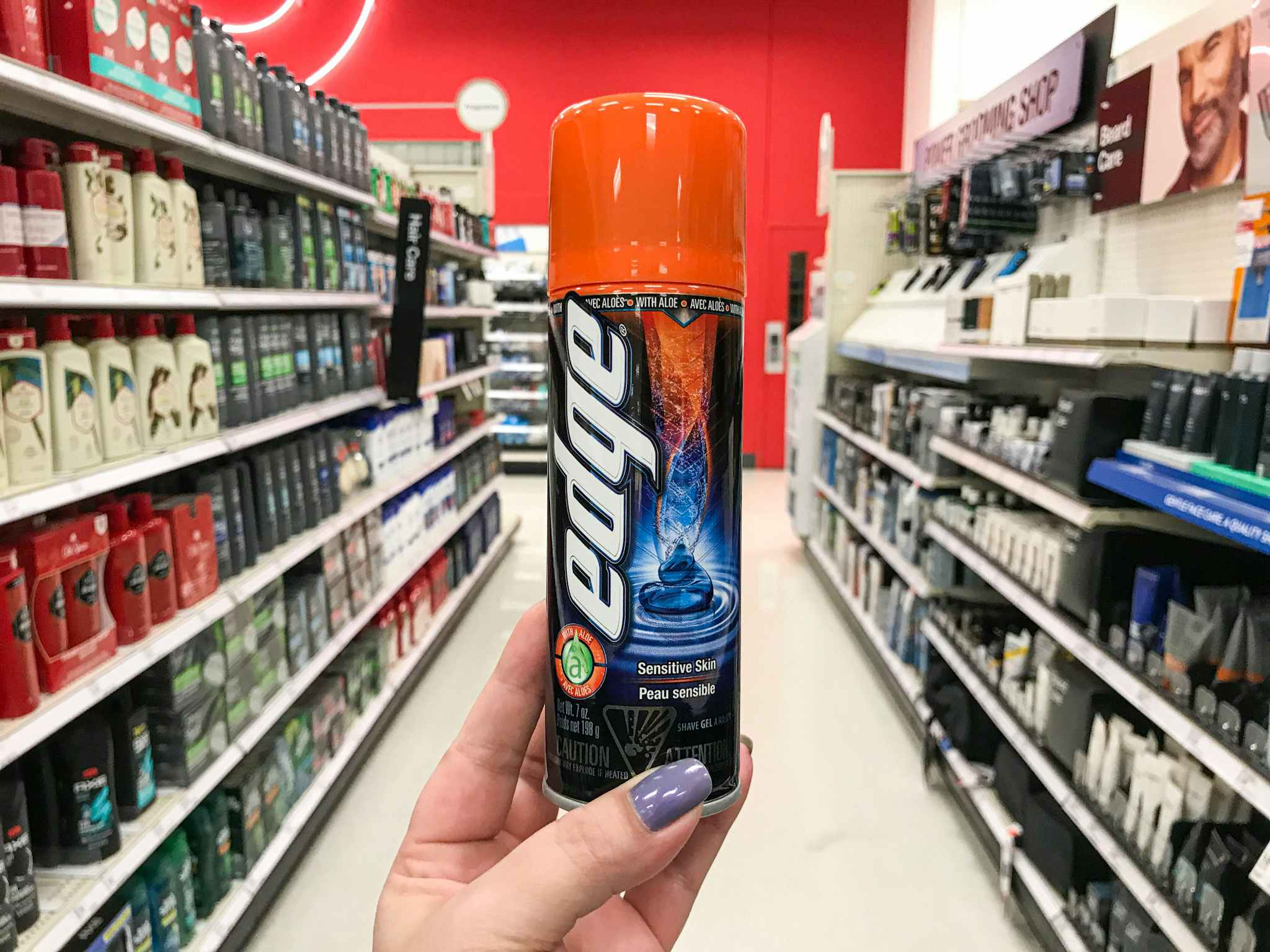 hand holding edge shave gel in a aisle at target