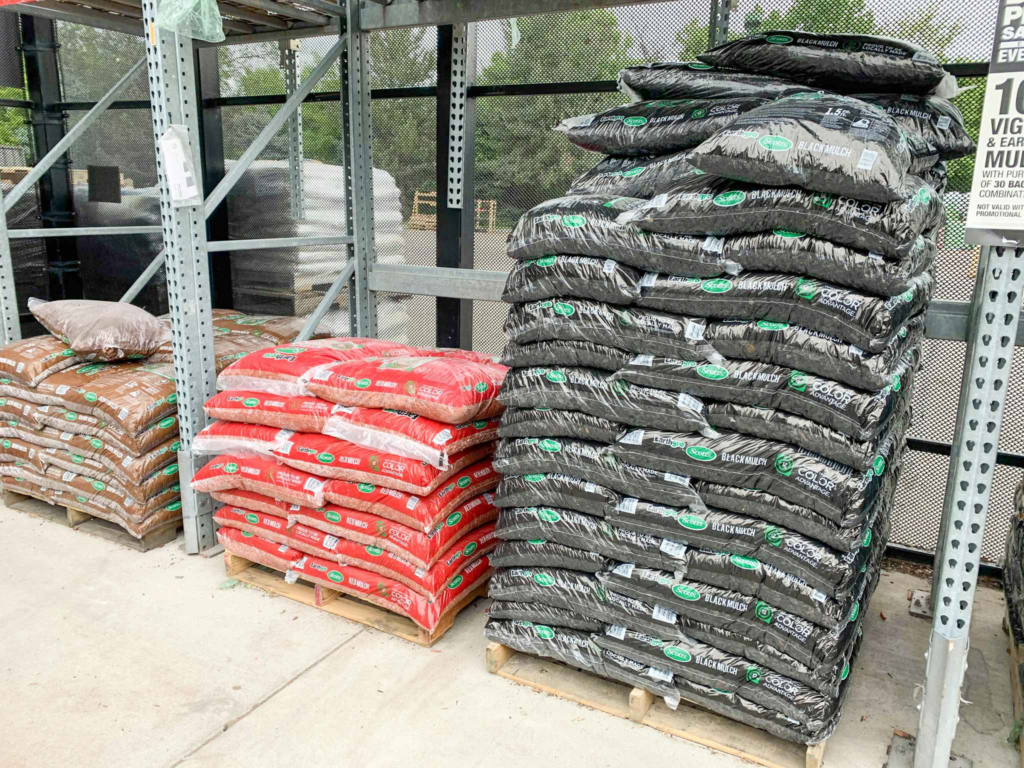 Piles of black, red, and brow mulch stacked next to each other. 