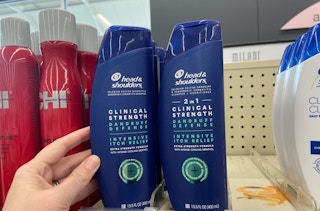 hands in front of head and shoulders bottles