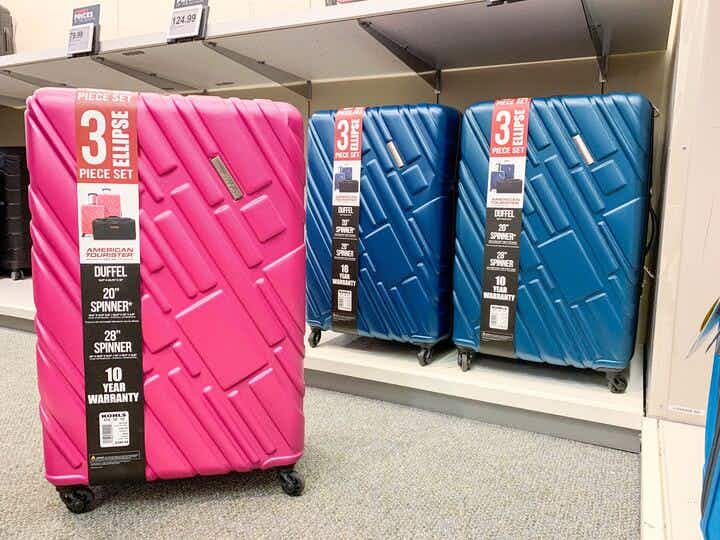 one pink two blue american tourister hardside spinner luggage sets on shelf