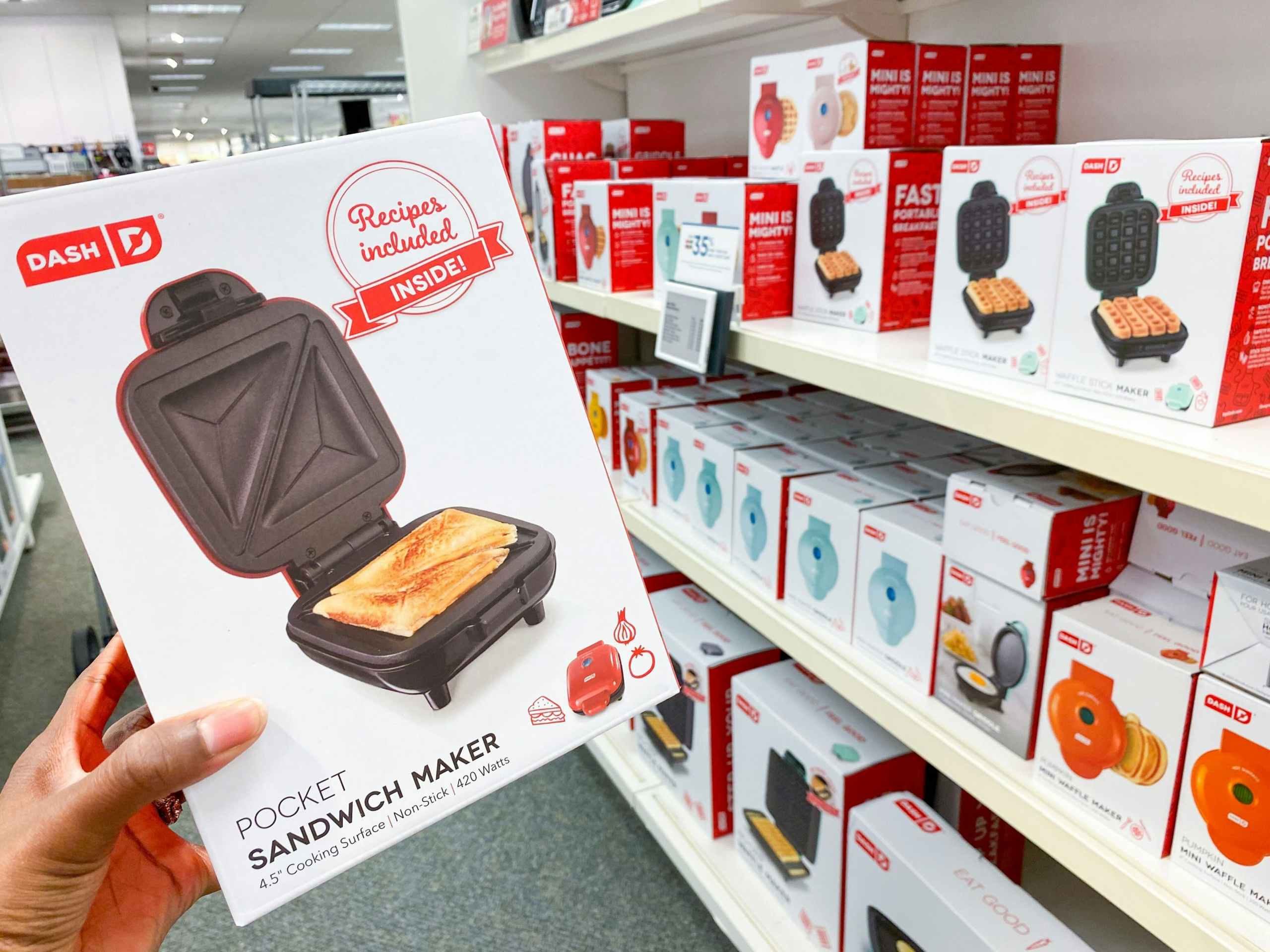 dash mini pocket sandwich maker with other appliances on the shelves in the background