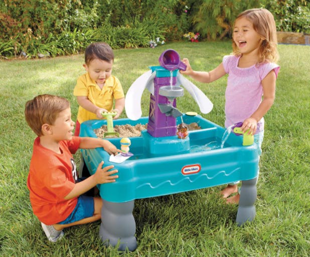 Kids playing at a combination sand and water table.