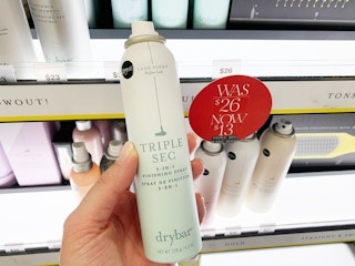 Woman holding Drybar Triple Sec spray at Sephora.