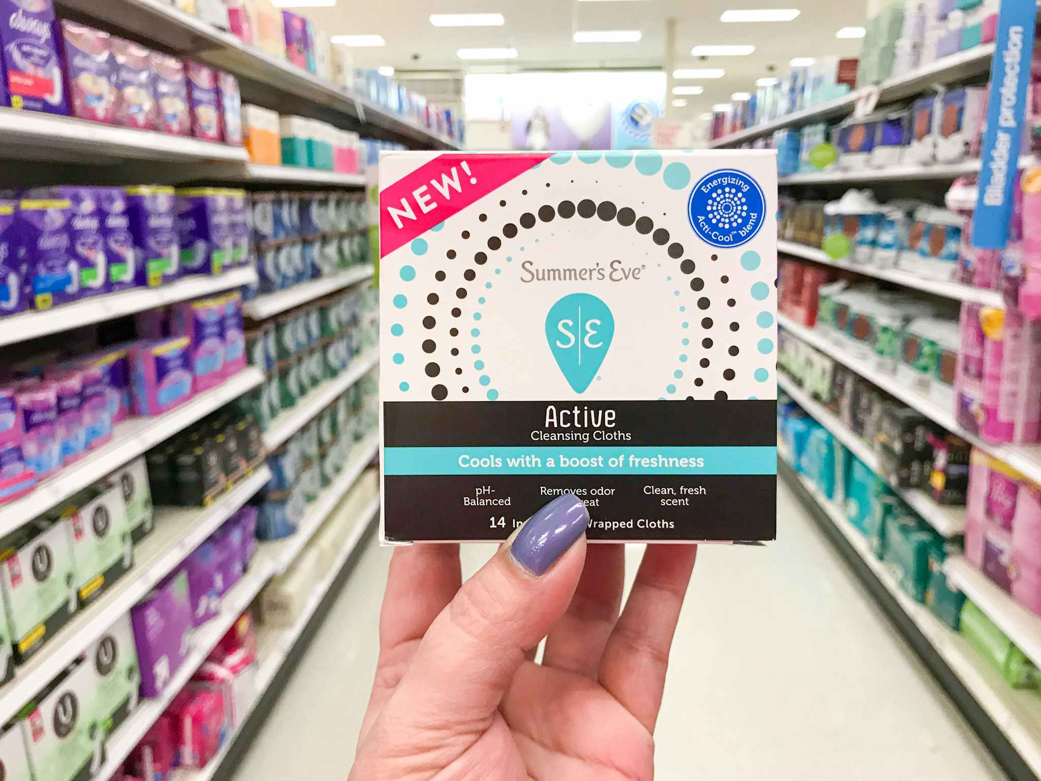 hand holding summer's eve active wipes in a target aisle