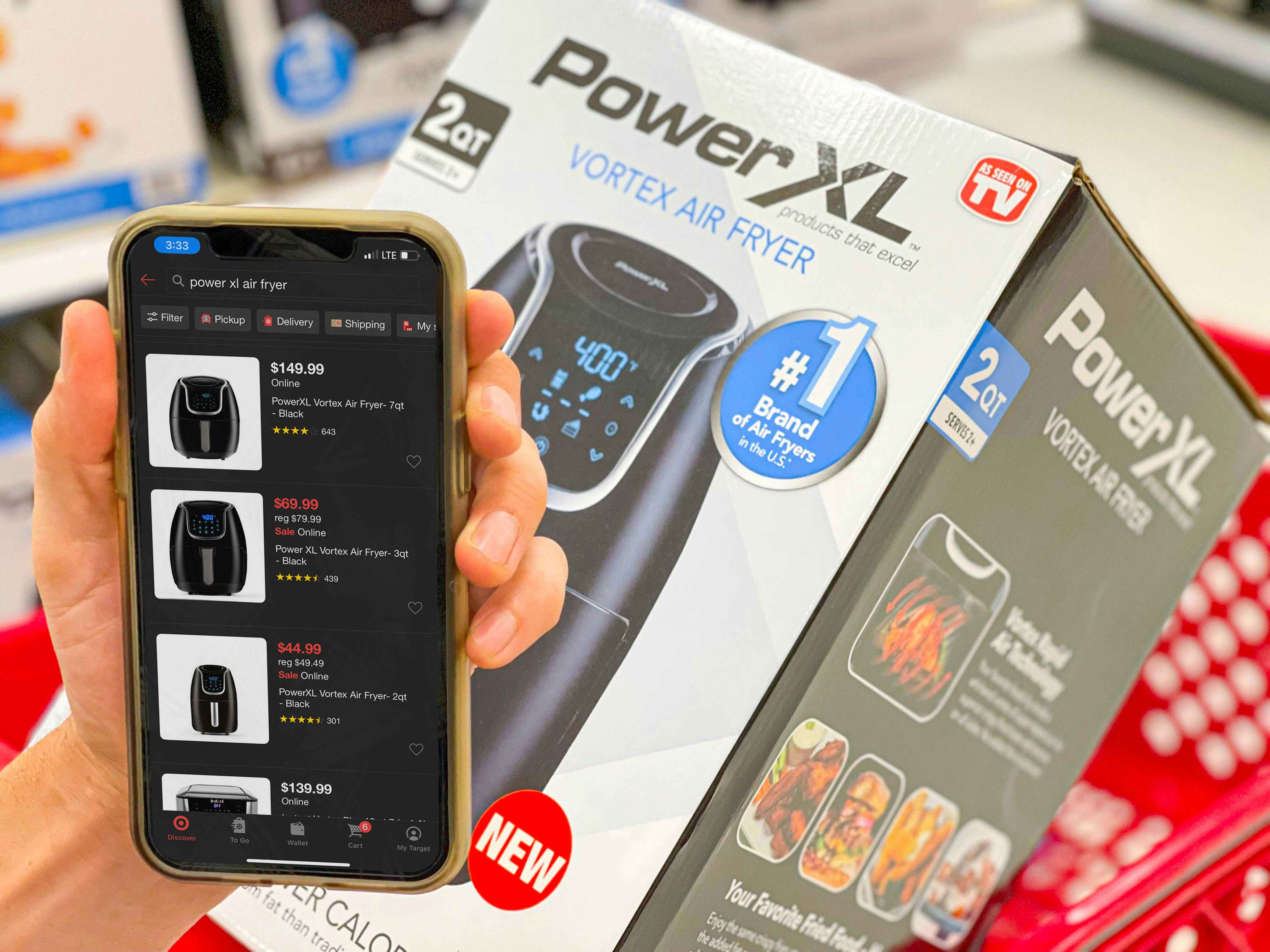 cellphone with target app in front of air fryer to compare prices while holiday shopping