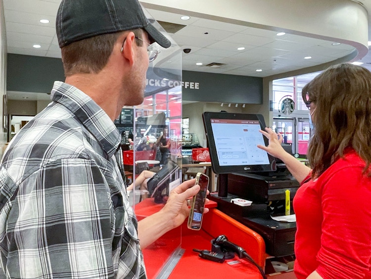 man showing cellphone to target employee