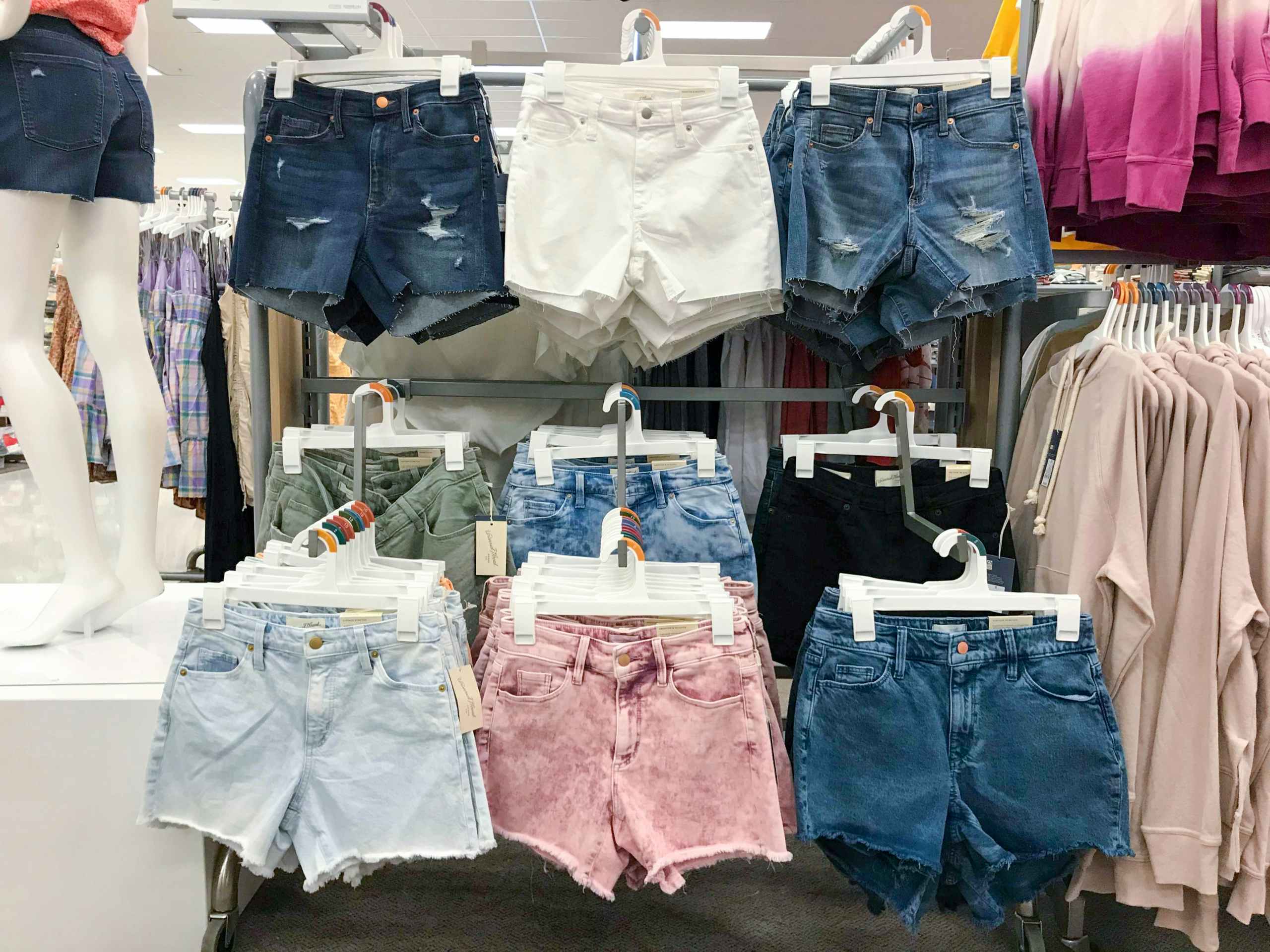 six pairs of hanging denim shorts at store