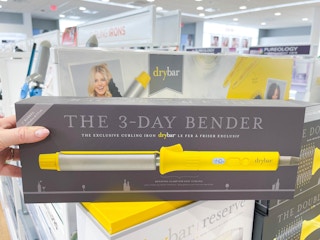 Woman holding Drybar curling iron