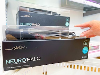 Woman holding Paul Mitchell styling tool